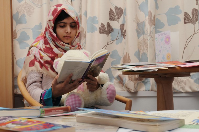 Image: Pakistani schoolgirl Malala reads a book as she recuperates at the The Queen Elizabeth Hospital in Birmingham